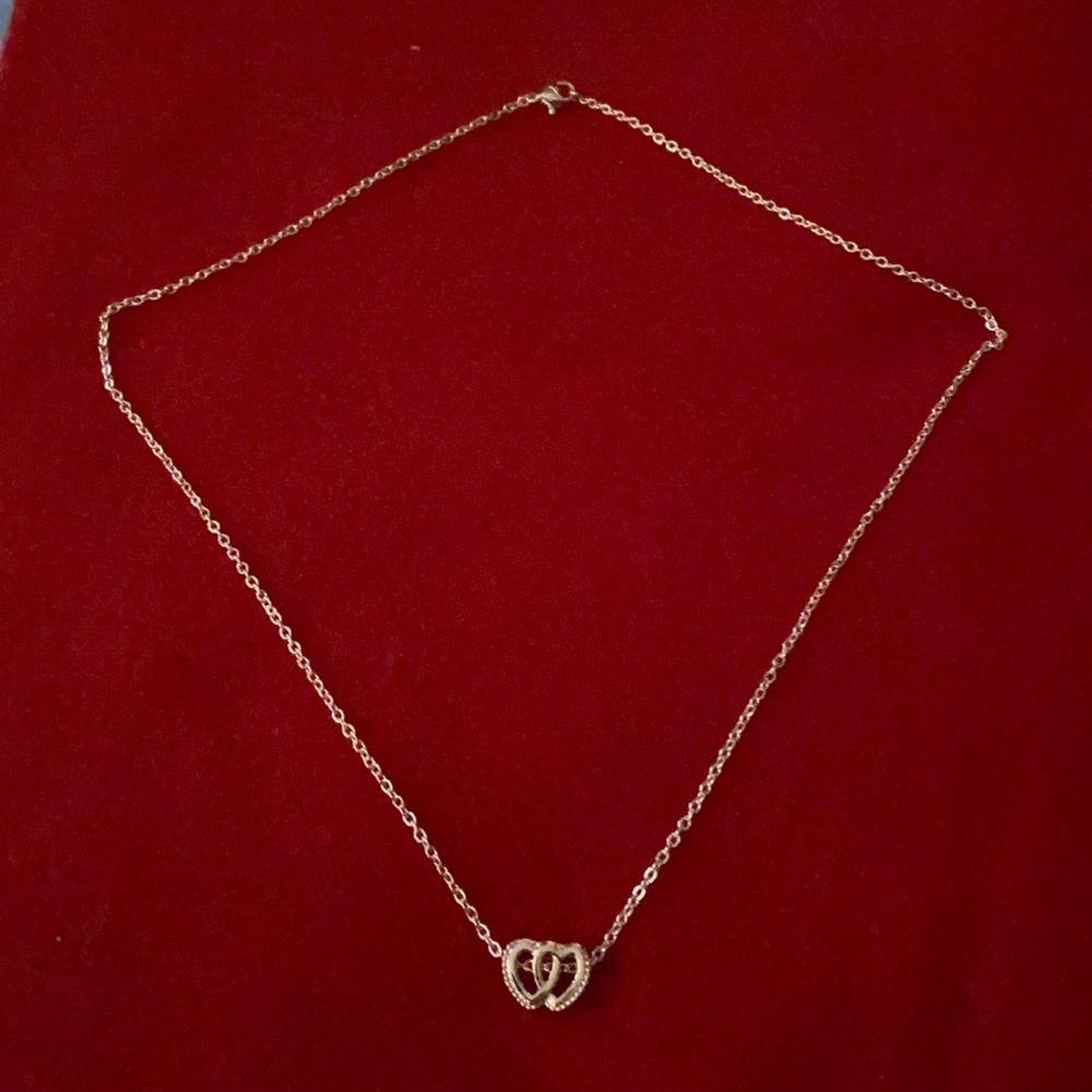 Rose gold necklace with double hearts charm.